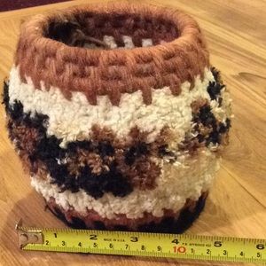 Basket, woven. Cream, brown, black yarns. Fuzzy.